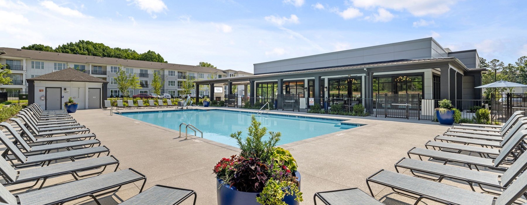 a swimming pool with chairs around it