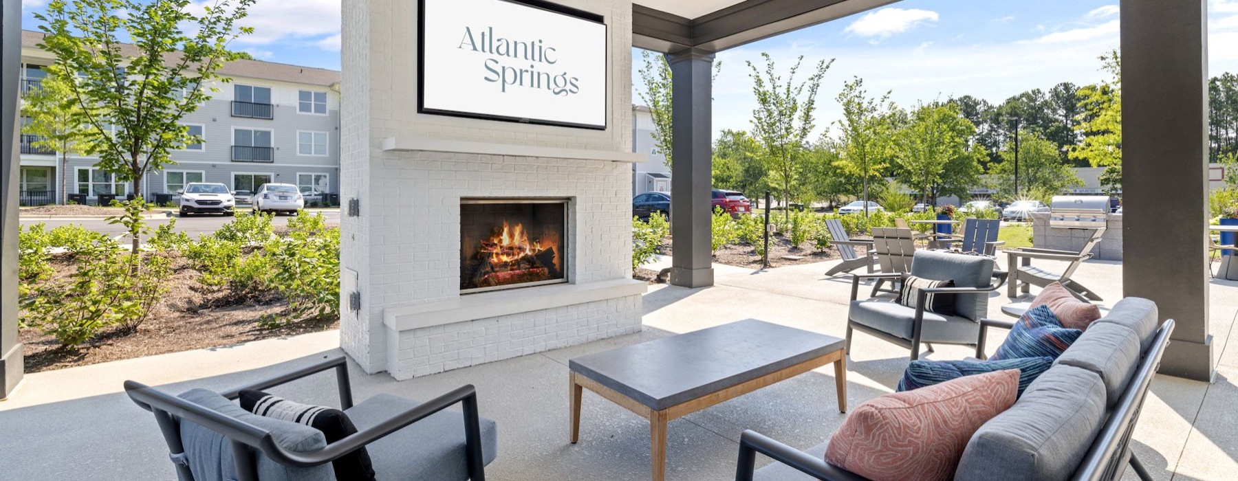 a patio with chairs and a fire pit